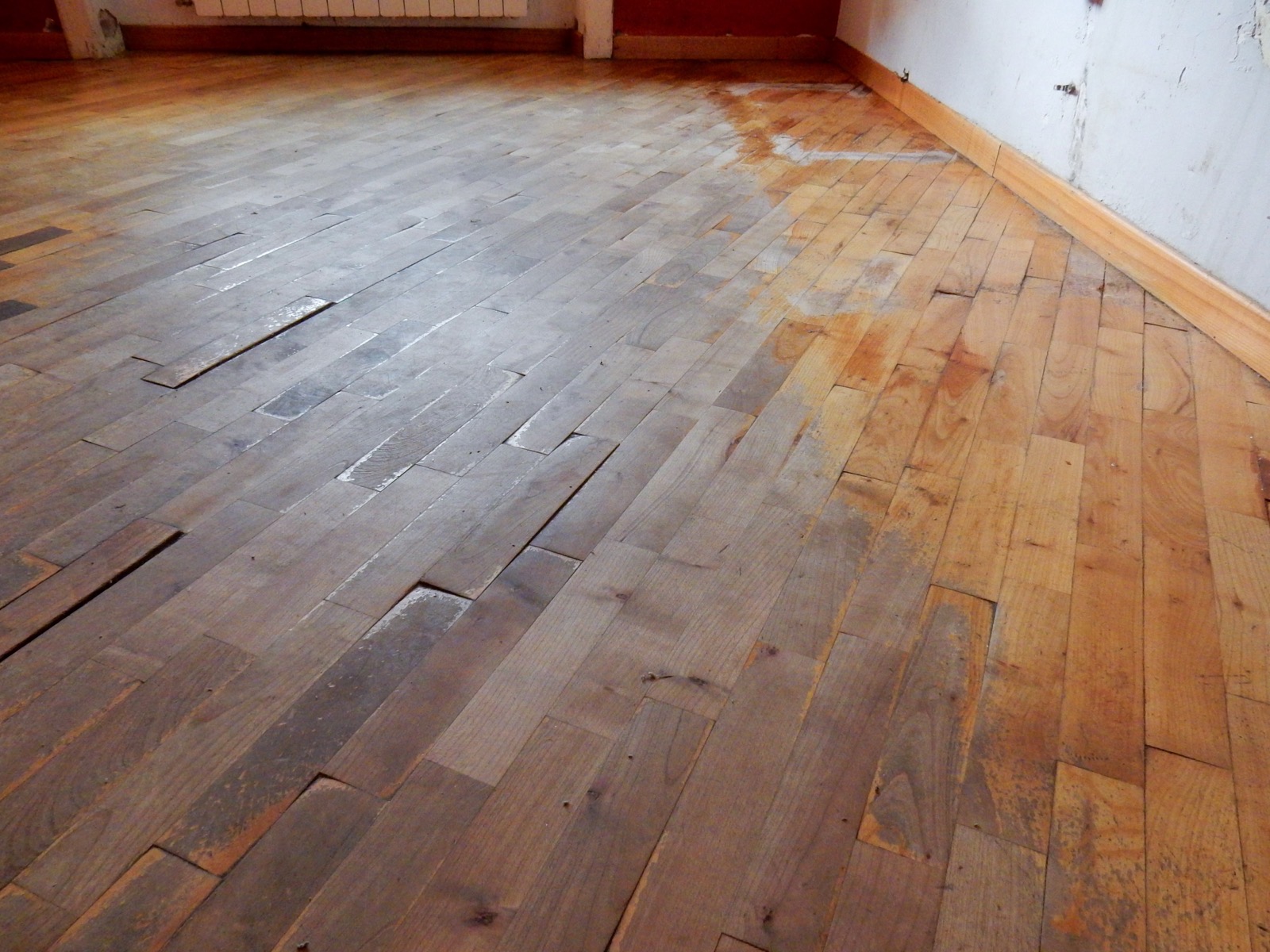 Hardwood floor boards distorted and lifting from moisture damage
