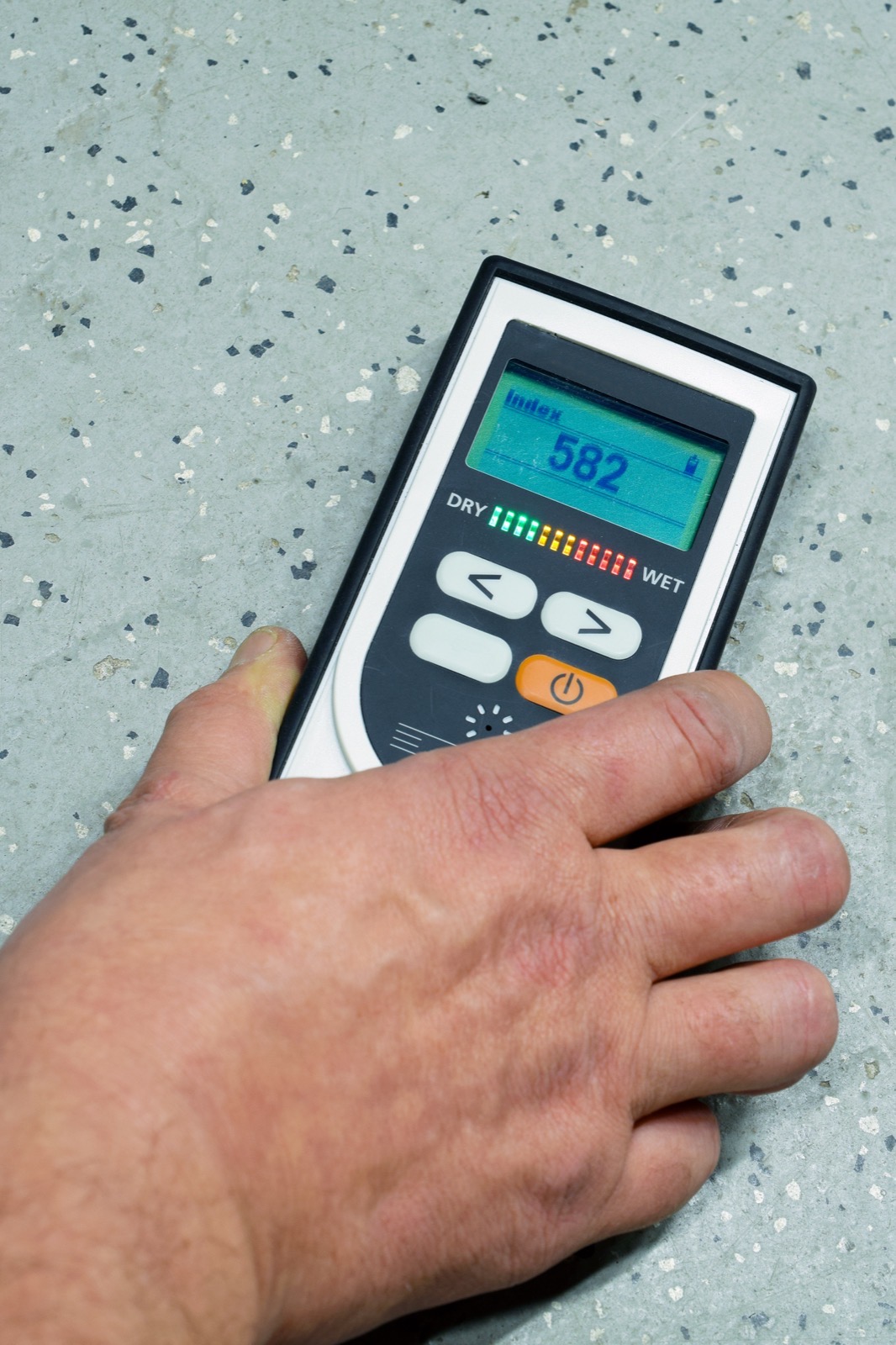 Measuring moisture on a concrete slab with a moisture meter