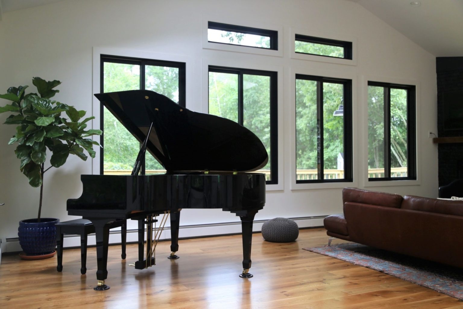 Grand piano resting on a wide plank oak floor