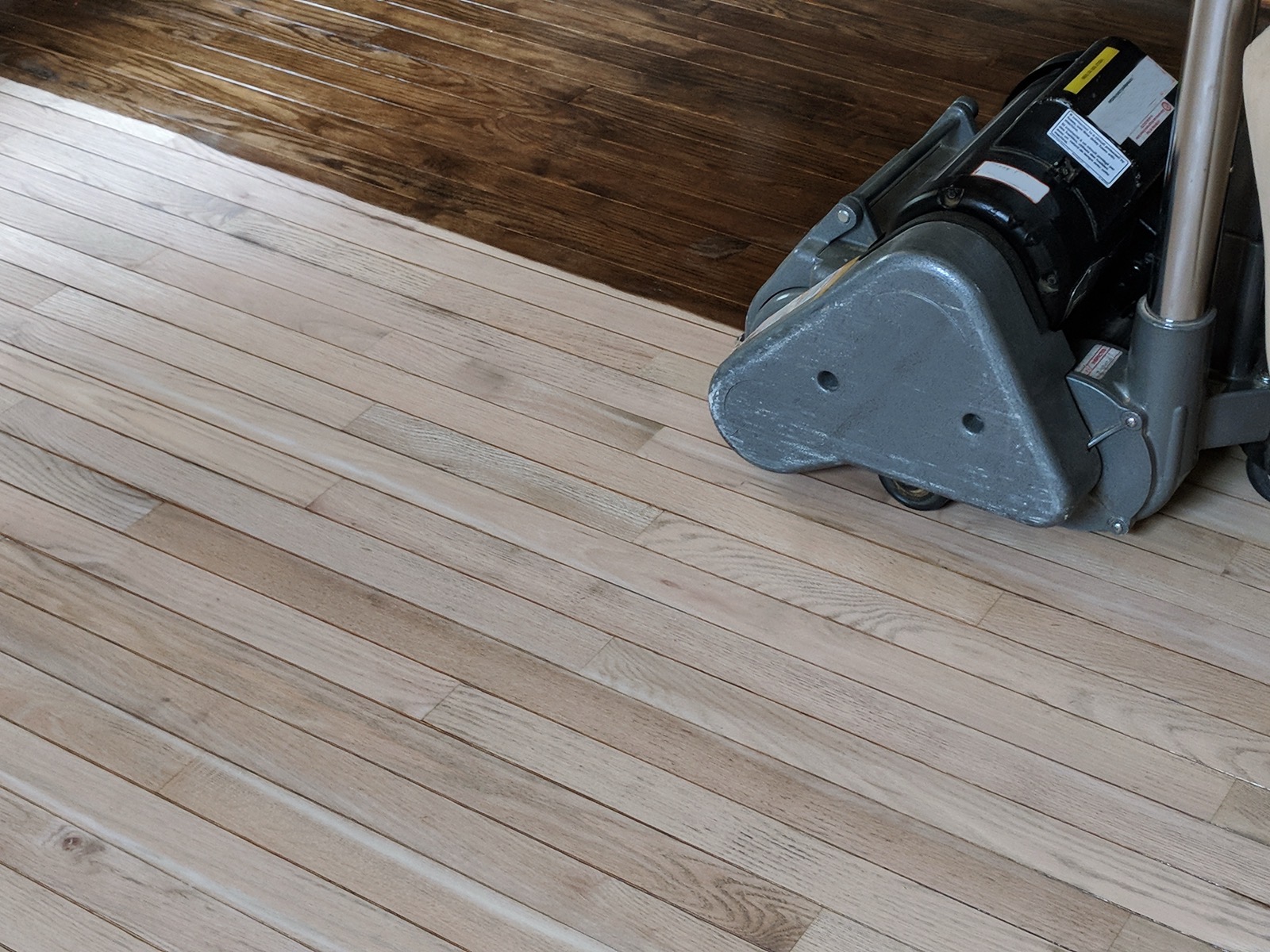 Floor sander removing old finish from a hardwood floor