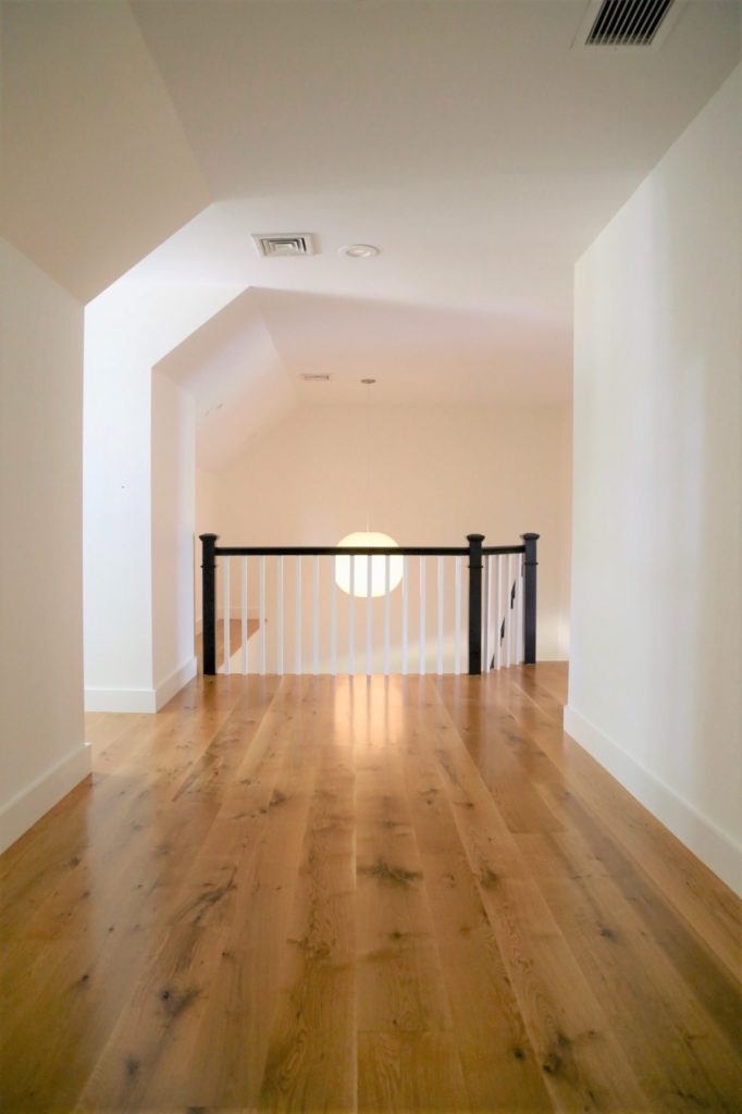 Long oak floor planks running down a hallway